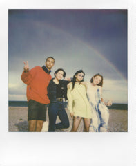 Polaroid film exiting a 600 camera mid-eject demonstrating instant development in use