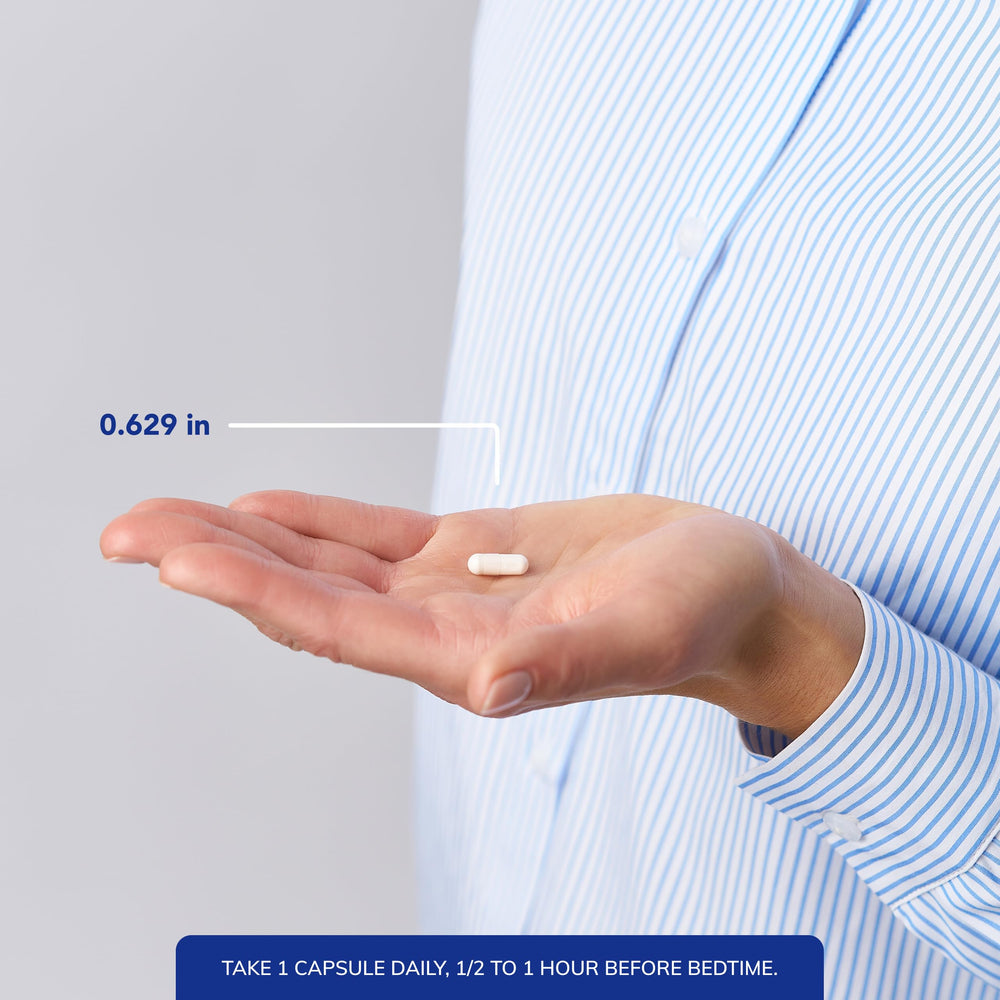 capsule next to a coin for scale demonstrating small size of Pure Encapsulations pill