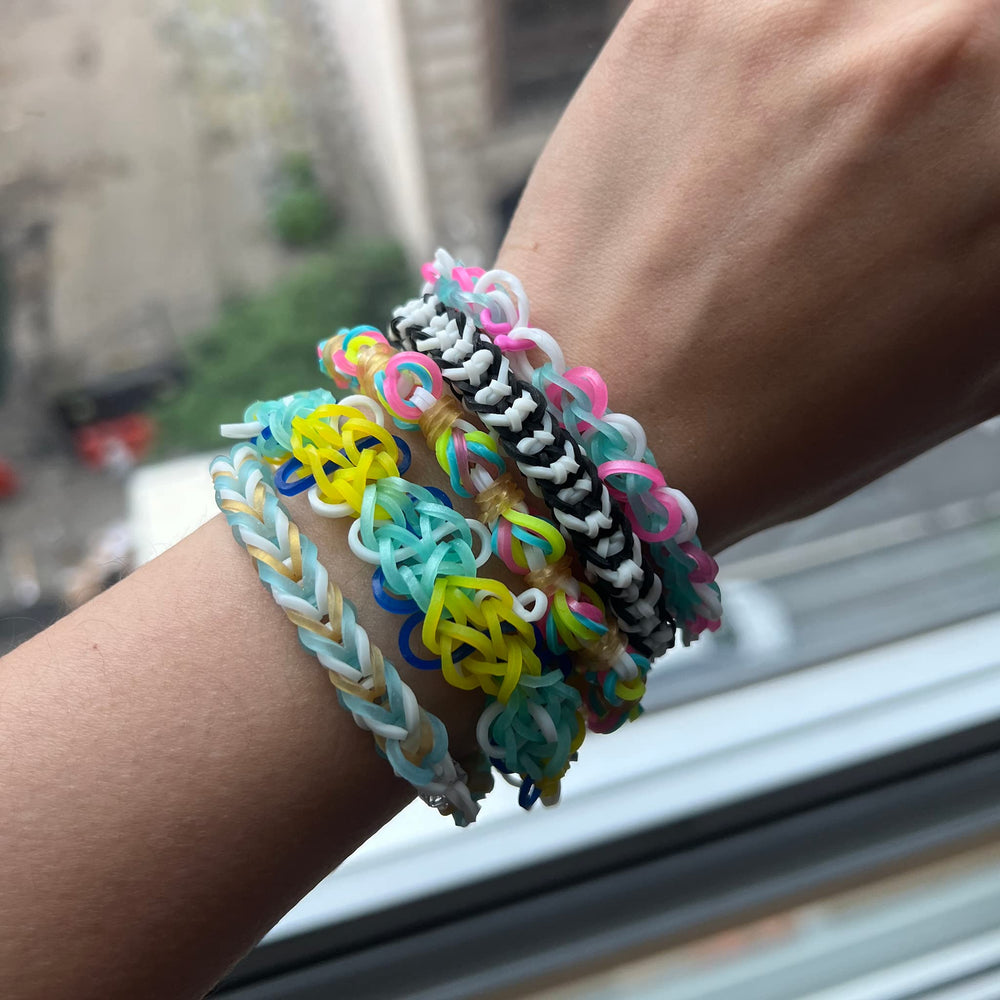 Rainbow Loom kit with hands for scale showing band count and kid-friendly size