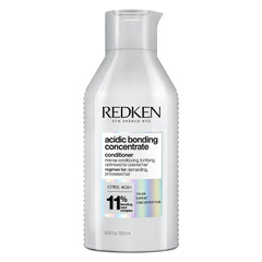 Redken bote frontal mostrando etiqueta y beneficio de reparación