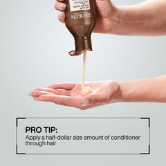 Hand holding Redken bottle to show 10.1 fl oz scale and portability benefit