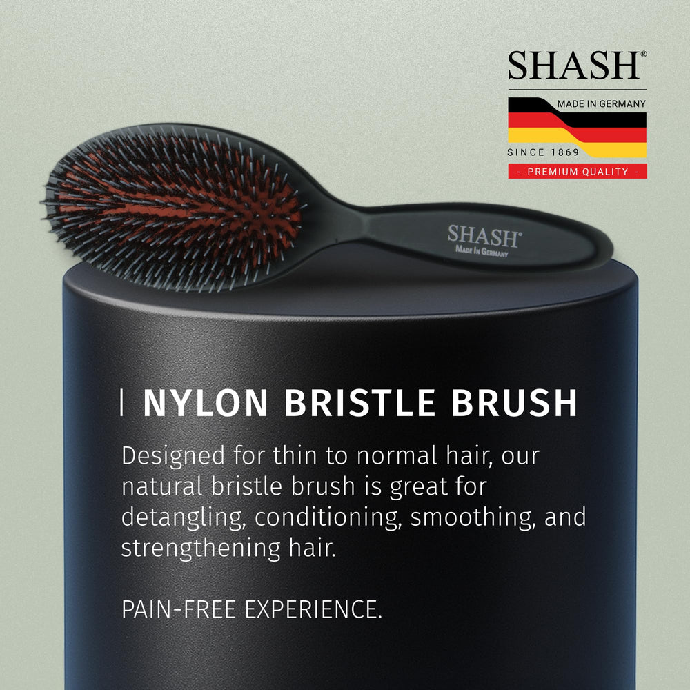 SHASH brush in hand to show scale and ease of control for daily use