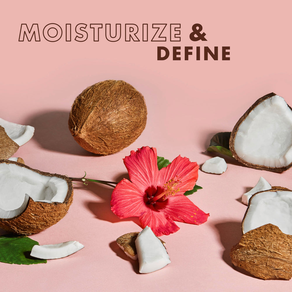 Shea Moisture botella abierta con gota de producto para ver consistencia rica