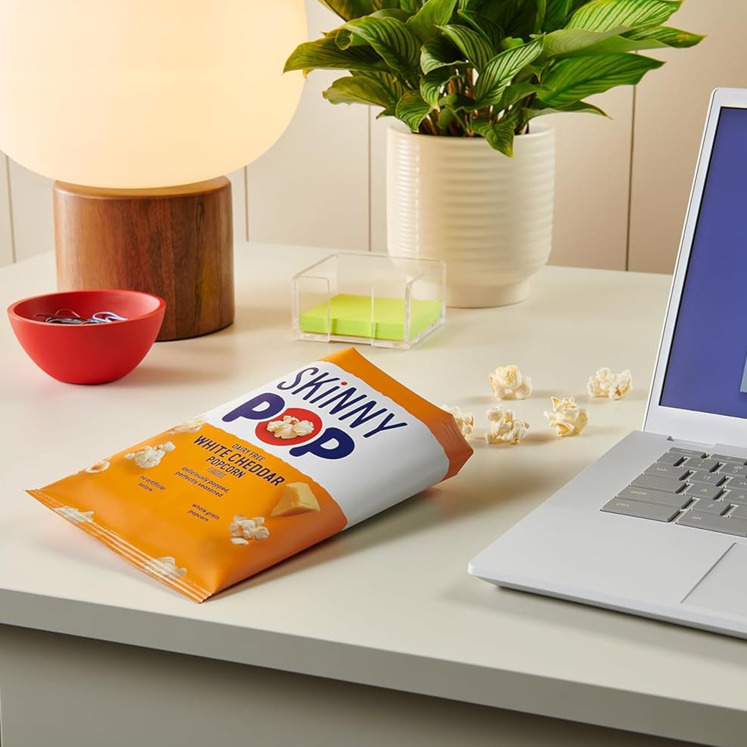 several SkinnyPop bags tucked inside a lunchbox demonstrating convenient school-ready portions