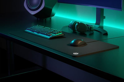 SteelSeries QcK next to keyboard and mouse for scale showing ample space for full setups