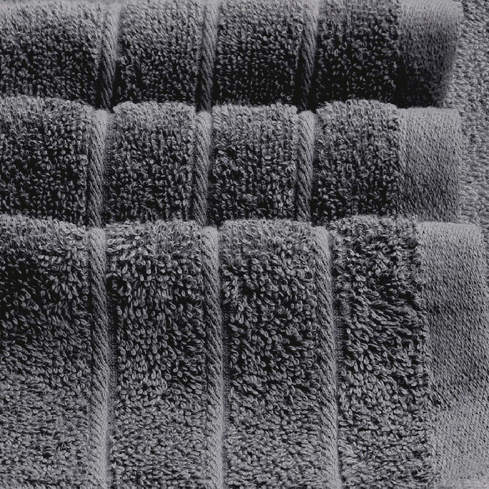 Tens Towels colocada sobre regla para comparar el tamaño 30 x 60 pulgadas y su gran cobertura