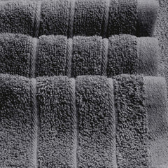 Tens Towels colocada sobre regla para comparar el tamaño 30 x 60 pulgadas y su gran cobertura