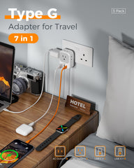 TESSAN adapter plugged into hotel wall powering several devices for travel convenience