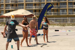 TidalBall in use on the beach with players tossing and social fun