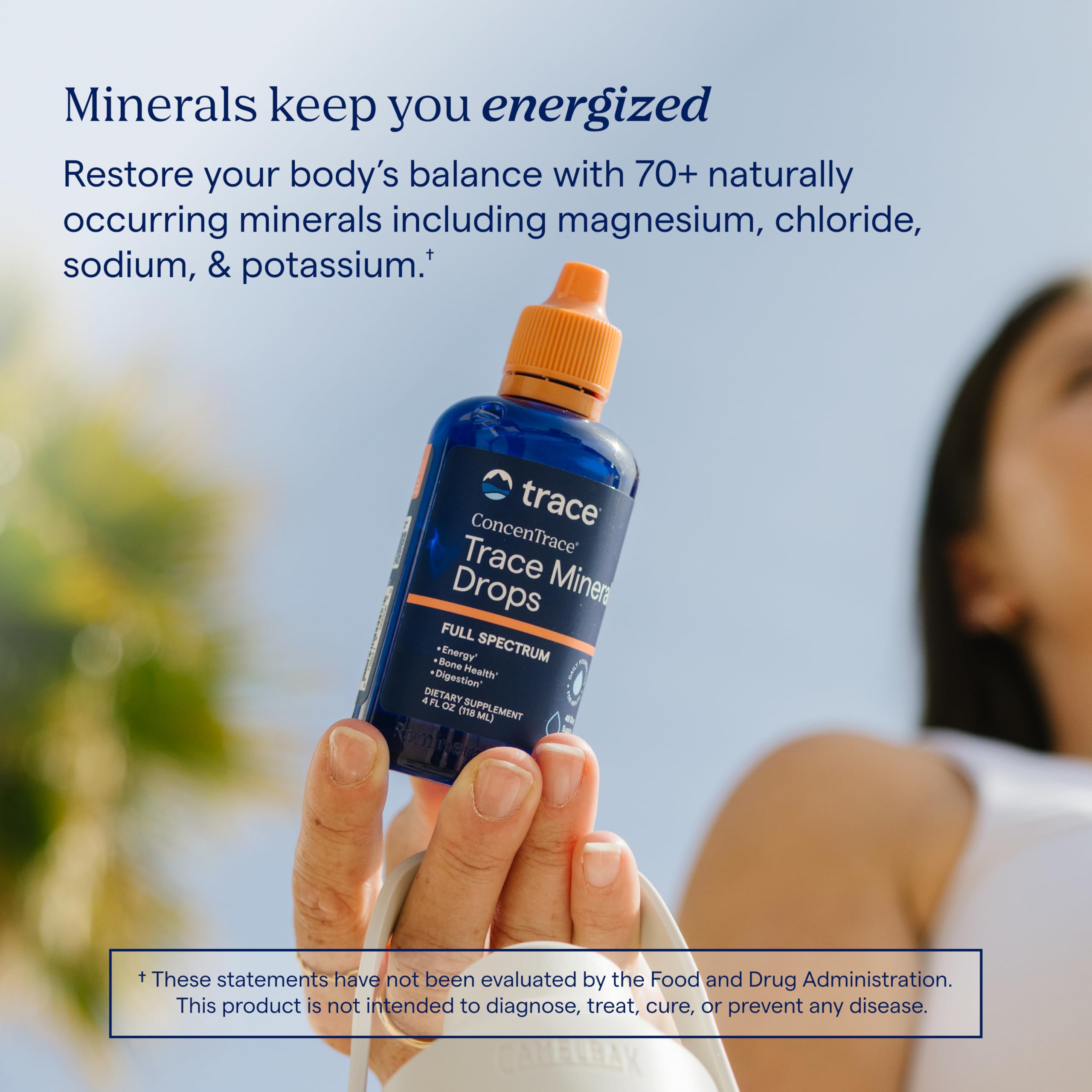 Trace Minerals bottle beside a hand for size comparison and portability advantage