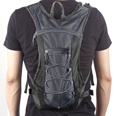Unigear next to water bottle showing pack size and 2L bladder capacity