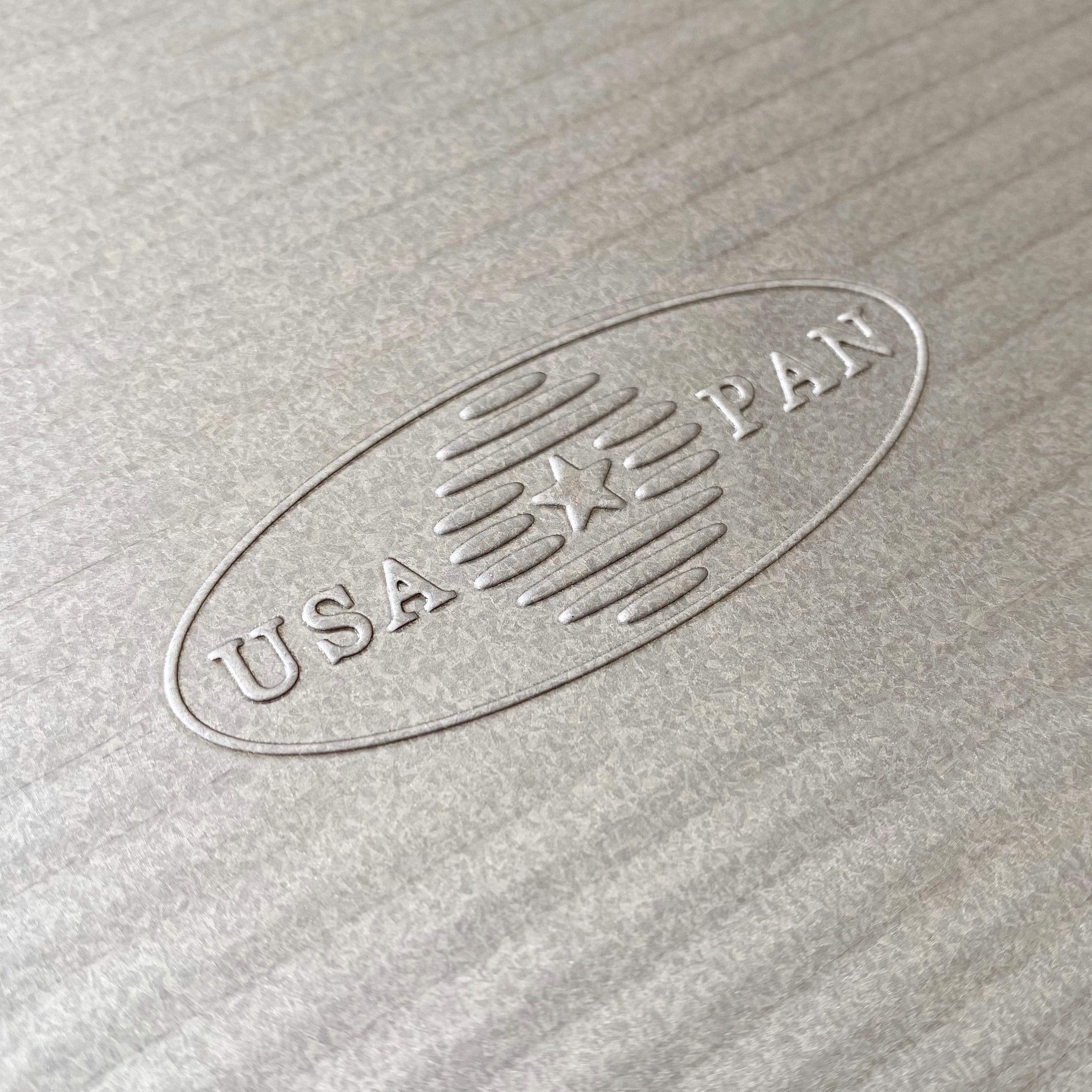 USA Pan etiqueta con material y recubrimiento AMERICOAT indicando limpieza fácil