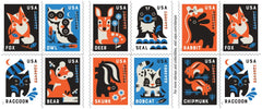 United States Postal Service sello Baby Wild Animals pegado en un sobre listo para envío