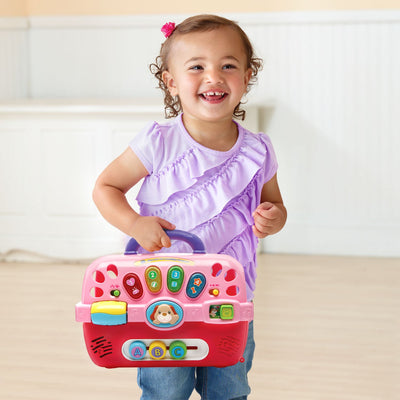 VTech carrier next to child's hand showing scale and easy portability