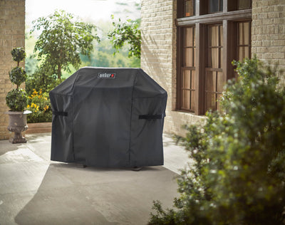 Weber cover next to grill showing scale and tailored fit benefit