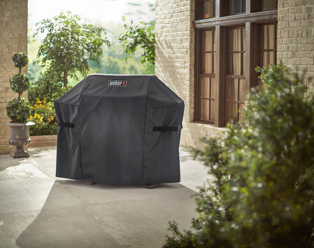 Weber cover next to grill showing scale and tailored fit benefit