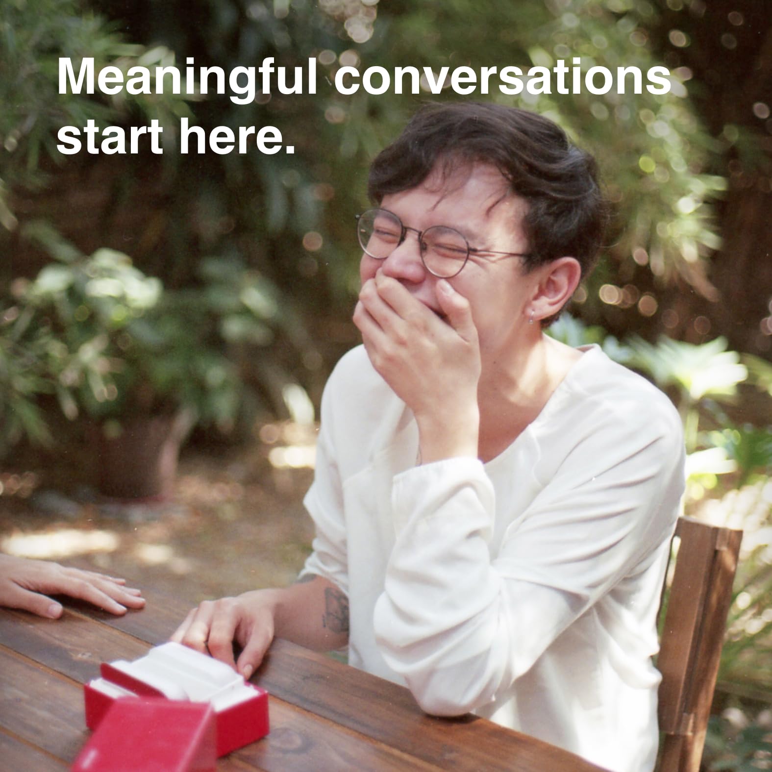 WE'RE NOT REALLY STRANGERS players around a table enjoying meaningful talk
