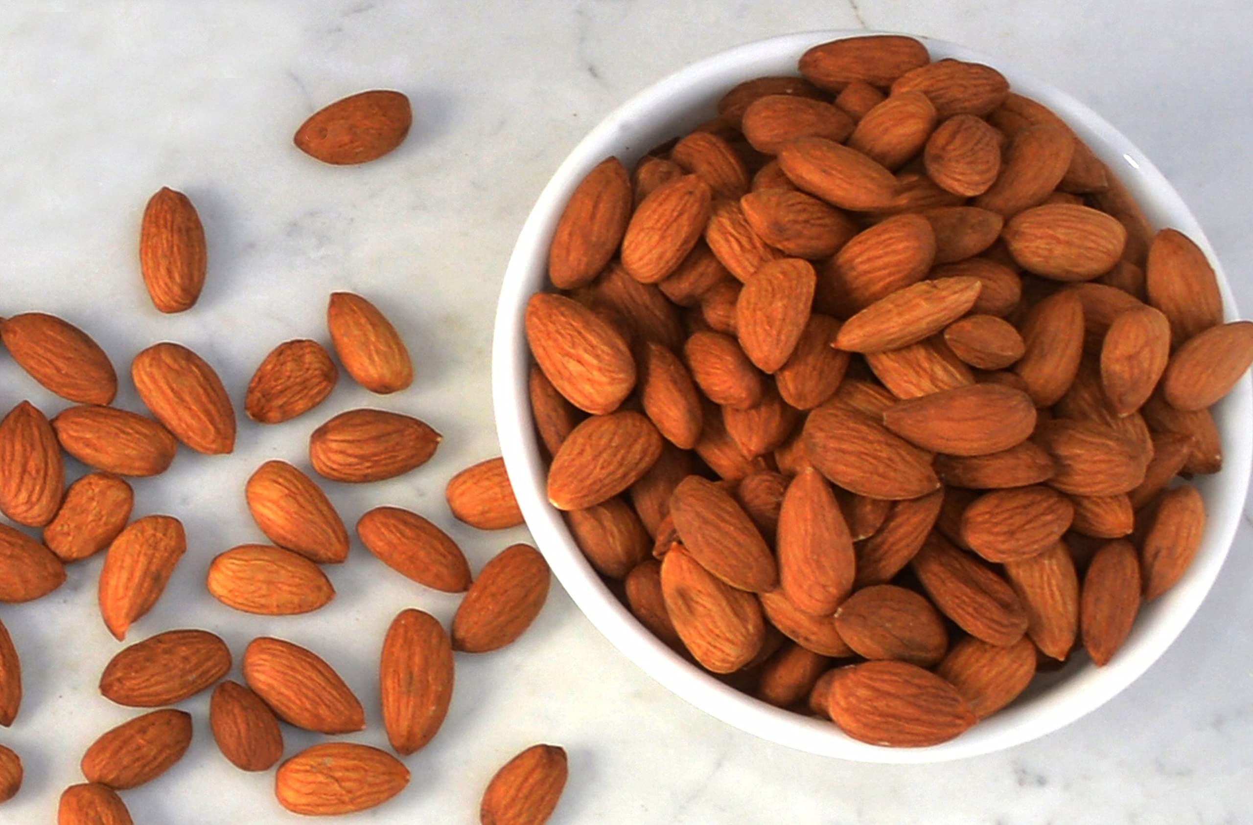Wild Soil almond held in hand demonstrating size and soft texture